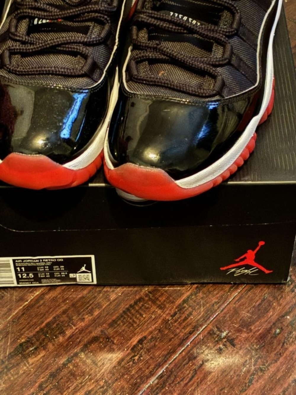 Jordan Menโs Black Patent Leather Sneakers with Red Outsole